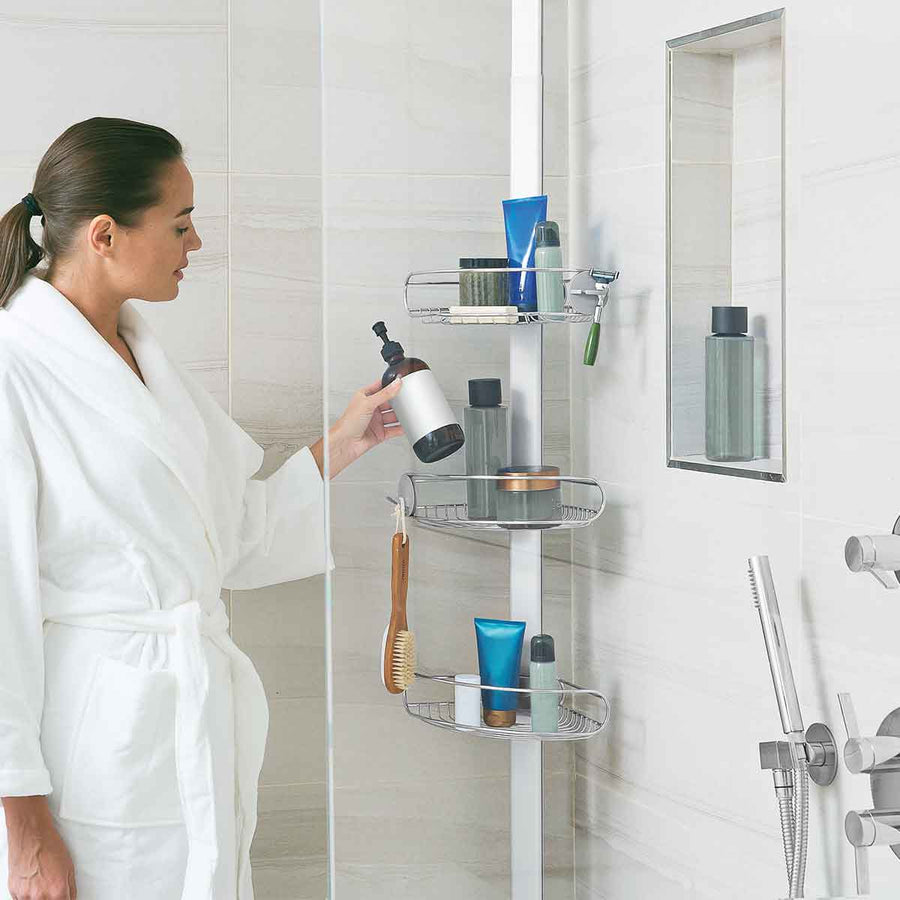 Lifestyle view of Simplehuman 9 Ft. Tension Shower Caddy, Stainless Steel, organizing items on adjustable shelves and hooks.