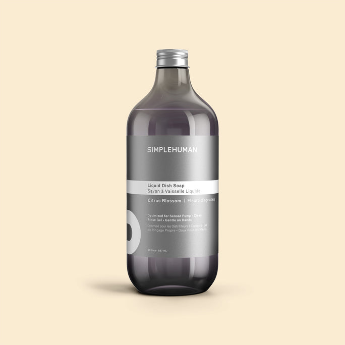 Simplehuman's Citrus Blossom Liquid Dish Soap Refill Bottle on a colored background.