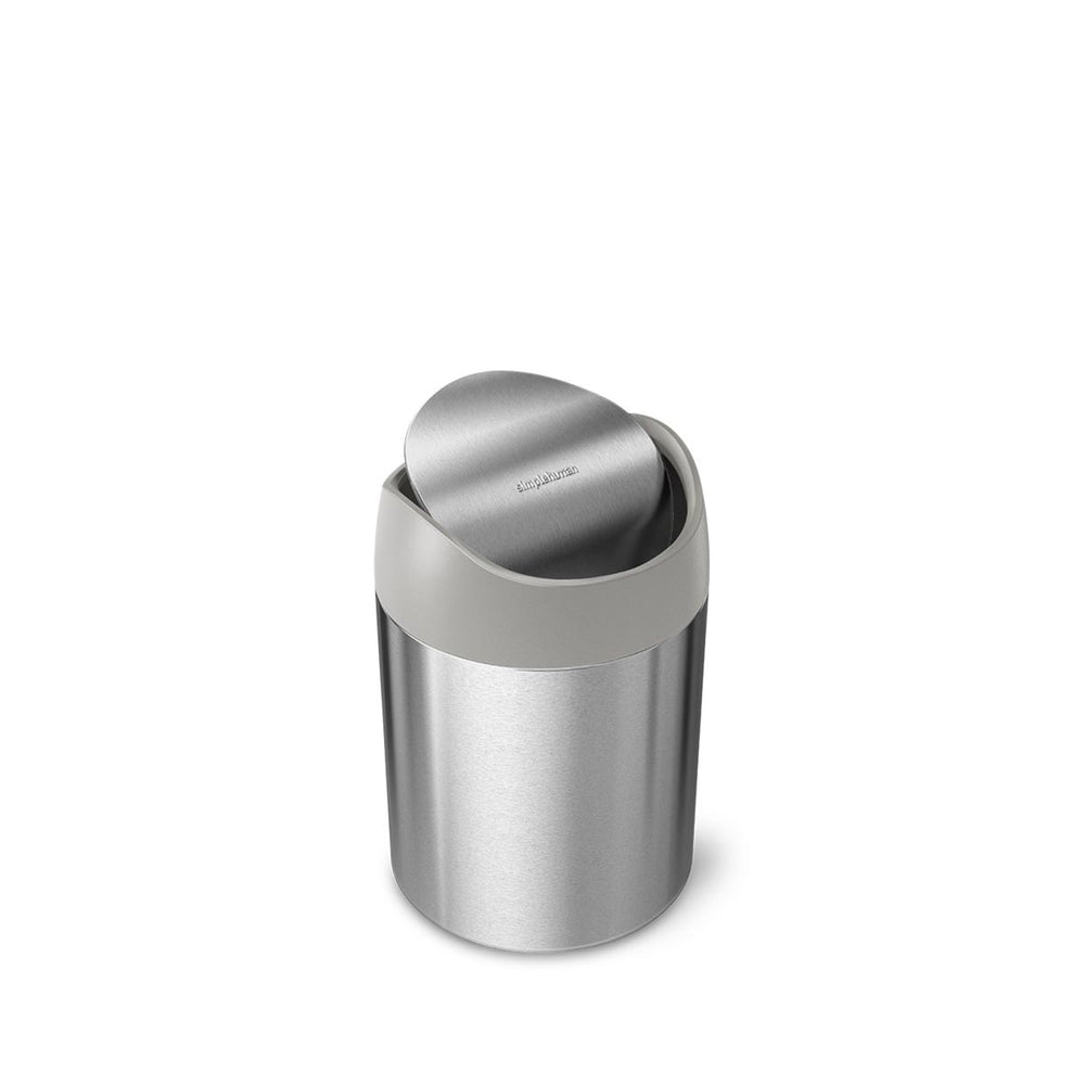 Angled view of Simplehuman 1.5L Mini Can, Brushed Stainless Steel, with pivoting lid for space-saving use.
