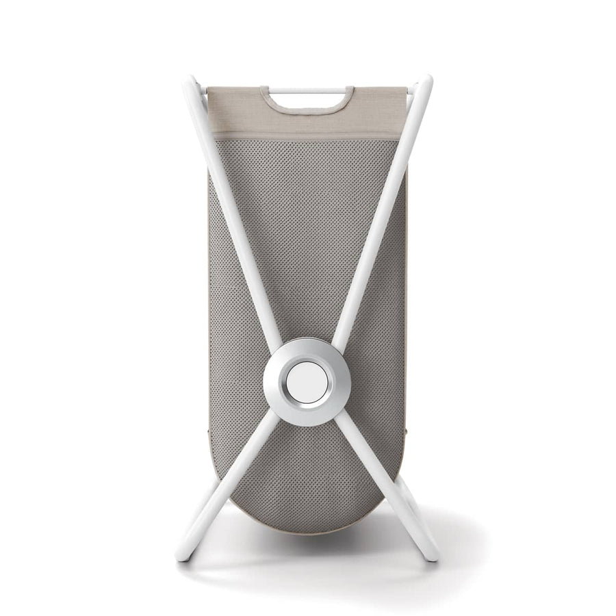 Side view of Simplehuman Double X-Frame Hamper, White frame, collapsed flat for space-saving storage.
