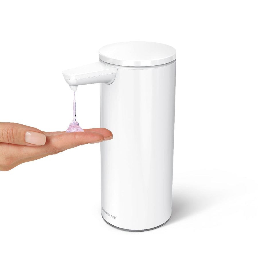 Simplehuman White 9 oz. Rechargeable Sensor Pump dispensing liquid soap, demonstrating touch-free, drip-free usage.