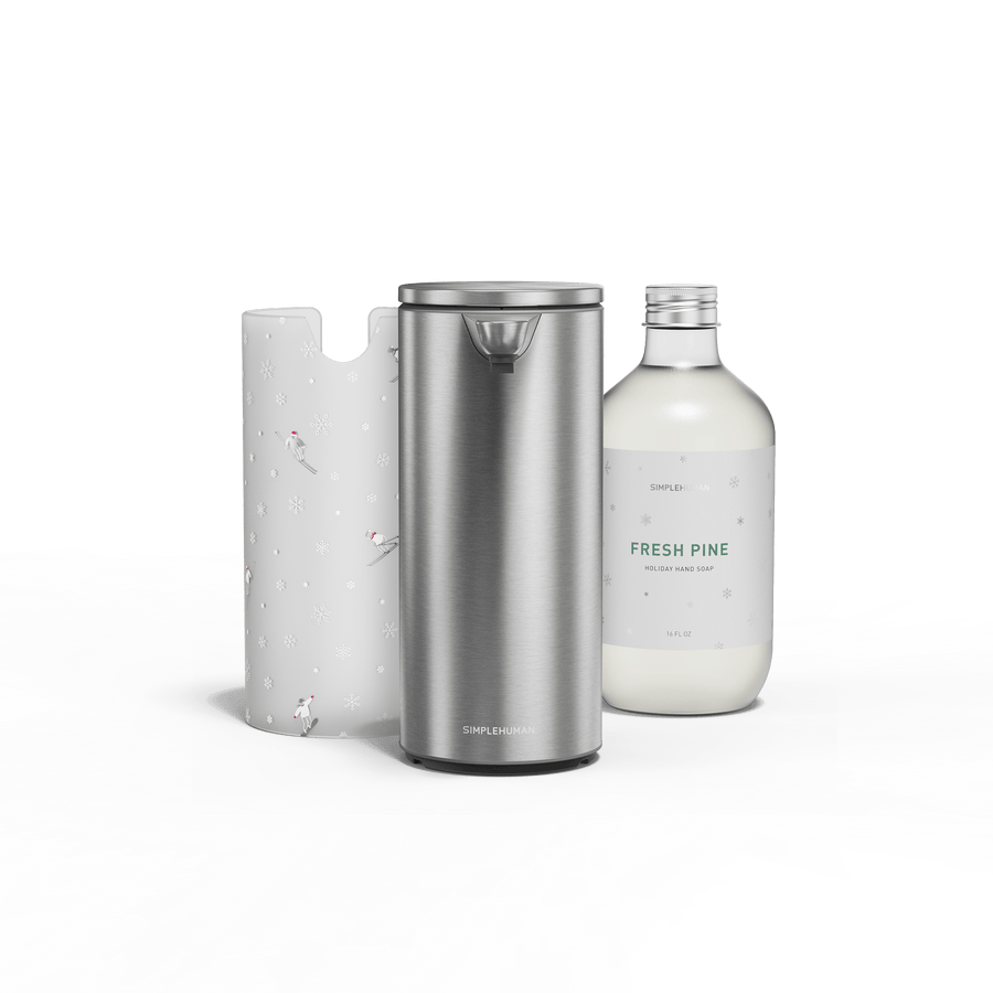 Simplehuman Holiday Kit - featuring Simplehuman's 9 oz. Liquid Sensor Pump in Brushed in the center and surrounded on left by their limited edition holiday sleeve featuring skiers on the left and their new bottled holiday soap in the scent fresh pine on the right.