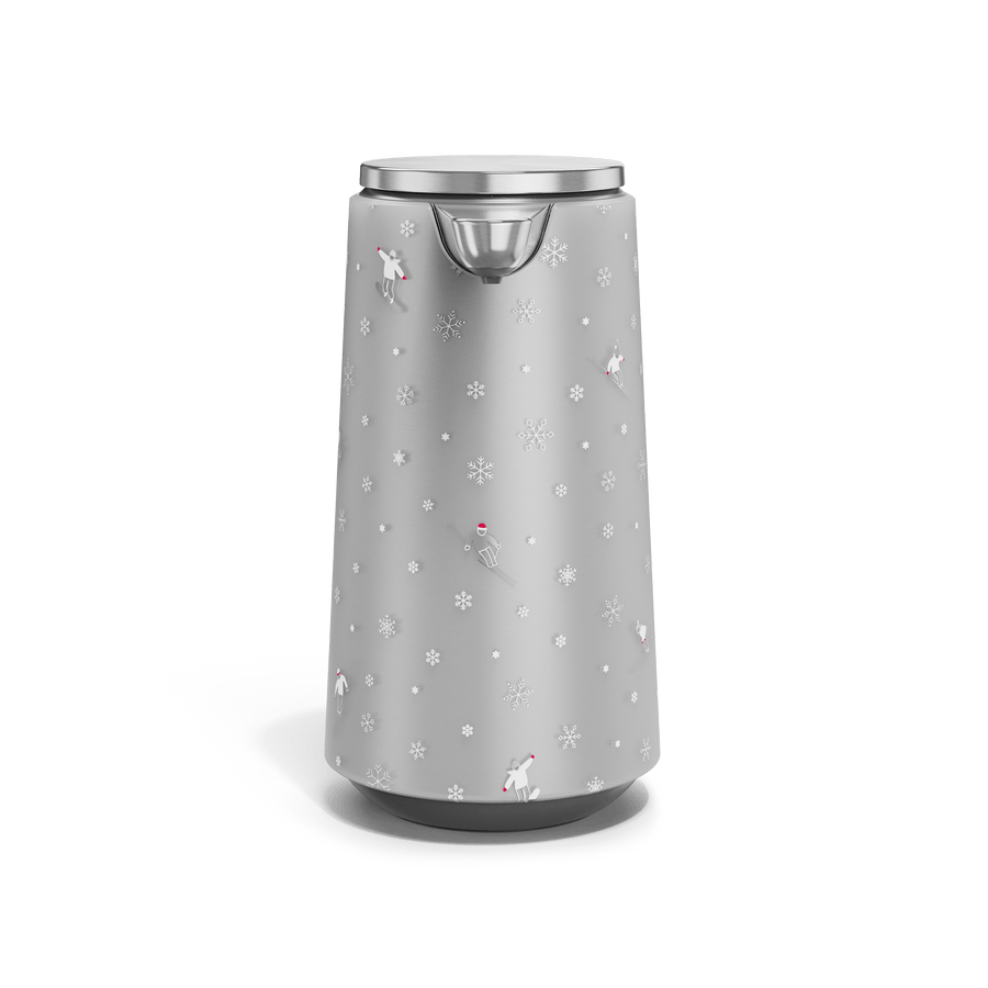 Front view of Simplehuman Brushed 10 oz. Sensor Pump Foam with holiday sleeve. White, frosted sleeve with skiers and snowflakes. 
