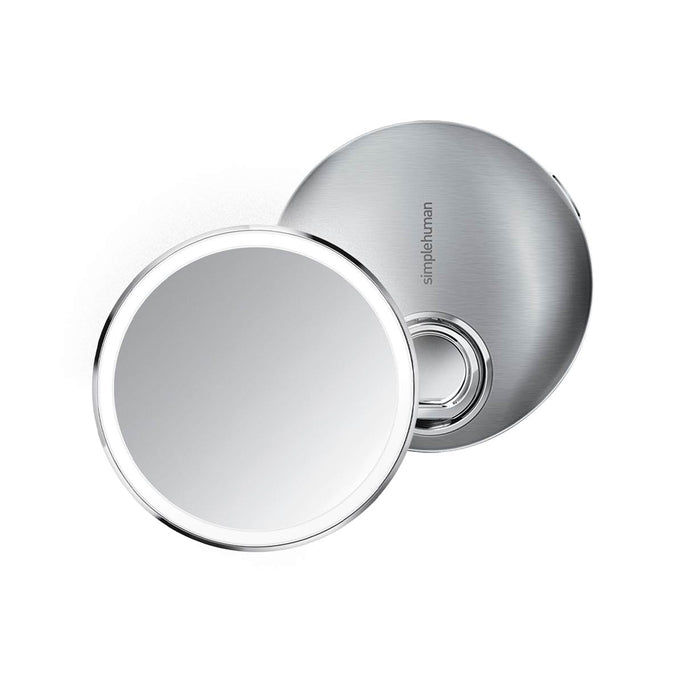 Simplehuman Sensor Mirror Compact 3x in Brushed Stainless Steel, open with sensor lighting, portable design.