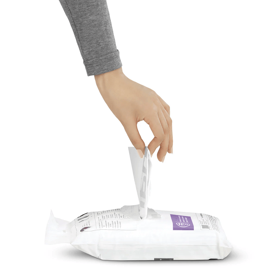 Hand pulling a single Simplehuman Code S trash liner from a white pouch.