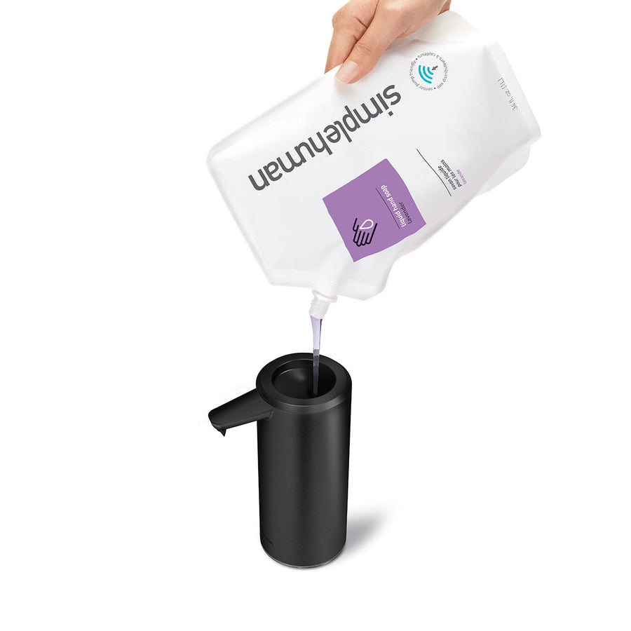 Simplehuman 9 oz. Sensor Pump in Matte Black being refilled using soap pouch, wide opening for easy refill.