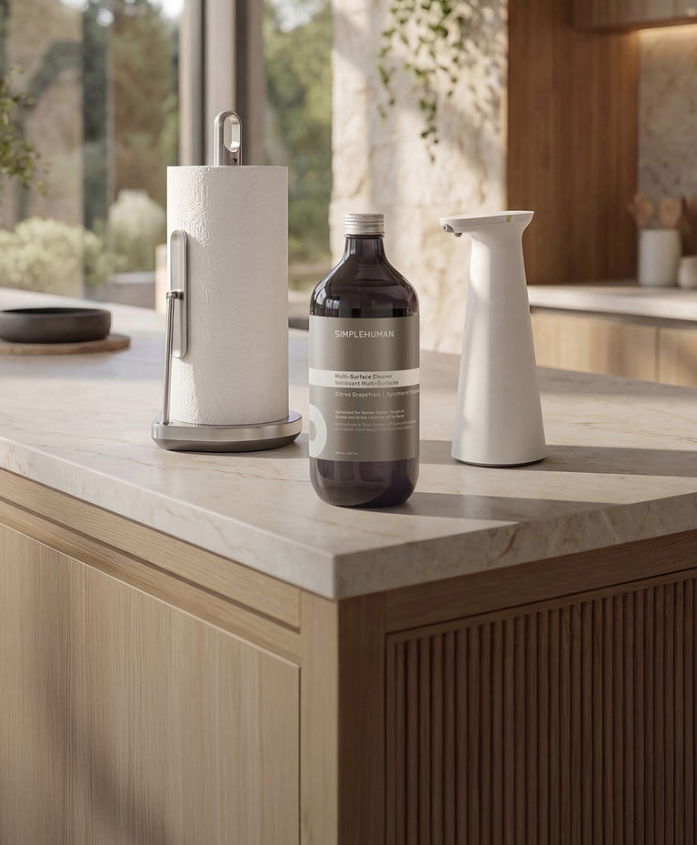Kitchen countertop with Simplehuman's Paper Towel Holder with Spray, Sensor Spray, and Multi-Surface Cleaner. 
