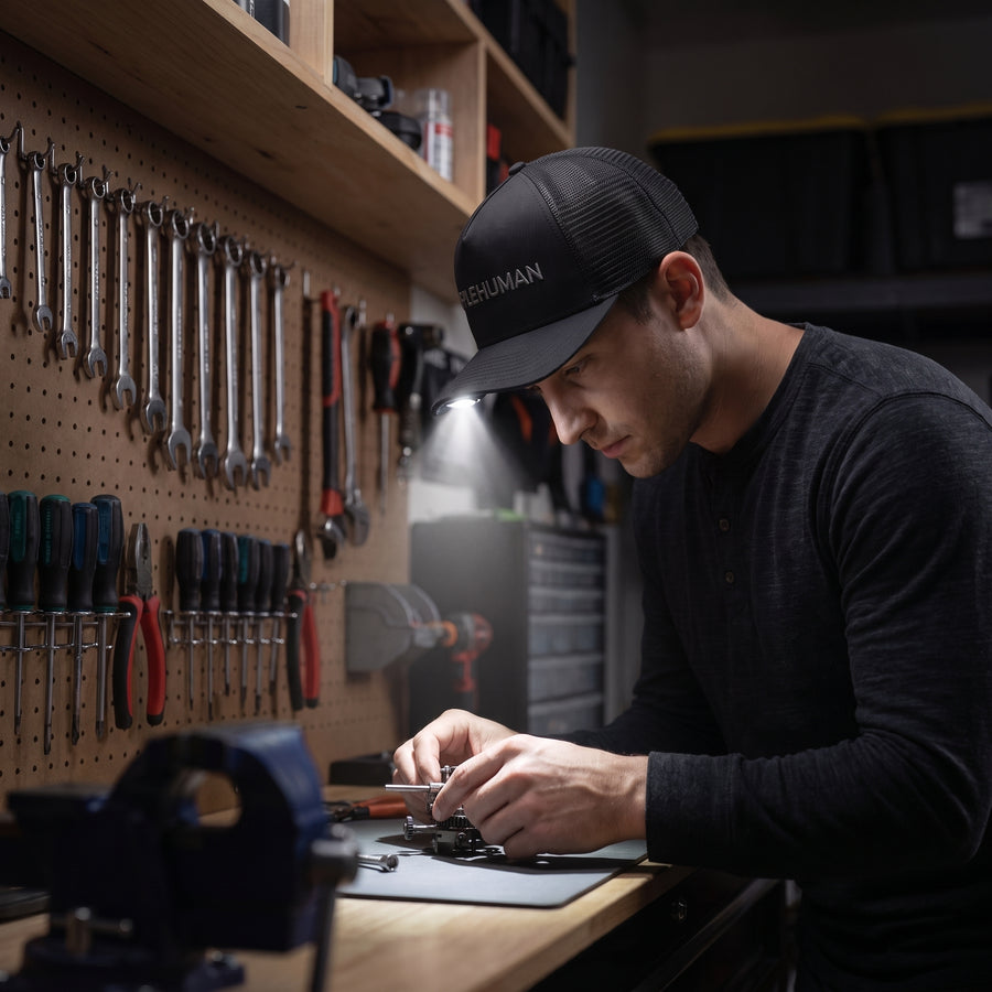 Simplehuman's LED Cap being used to work with tools in the garage in a dark setting. 