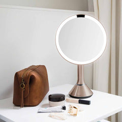 sensor mirror with touch-control brightness - rose gold finish - lifestyle with cosmetics
